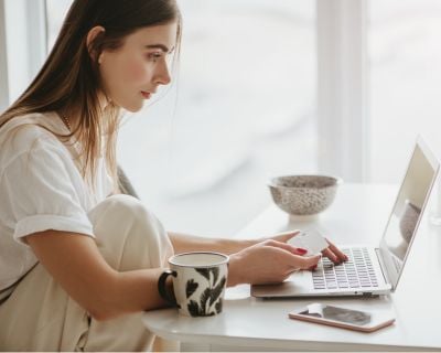  Young woman ordering an at-home STD test kit on her laptop at home